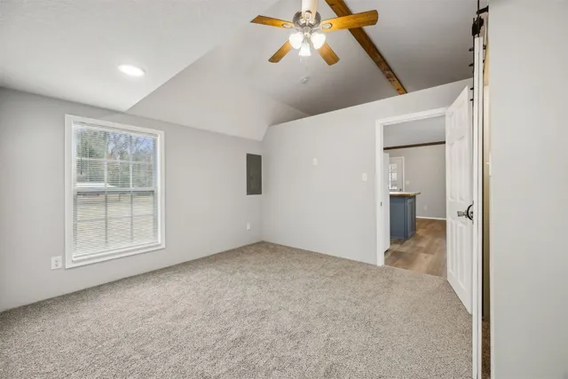 an empty room with windows and cabinet