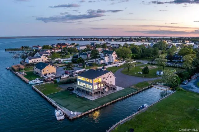 an aerial view of a house with a garden and lake view
