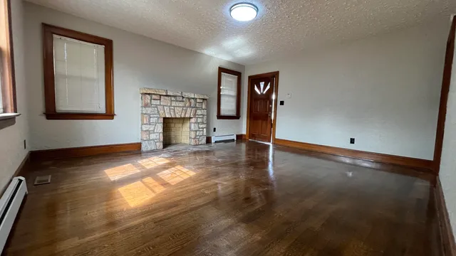 wooden floor in an empty room with a fireplace