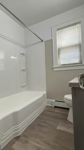 a bathroom with a bathtub and a window