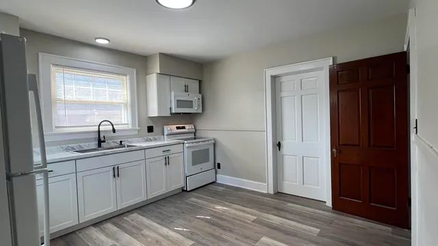 a spacious bathroom with a double vanity sink and a mirror