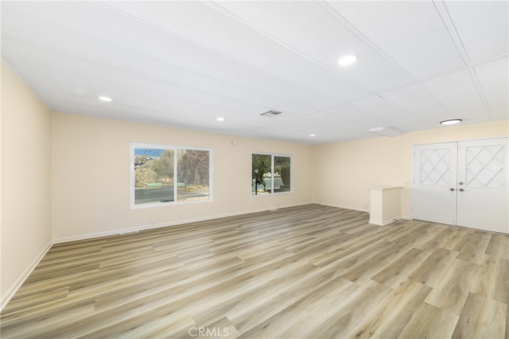 40975 Laredo Trail Cherry Valley, CA 92223 - Photo 18 of 34 a view of an empty room with wooden floor and a window