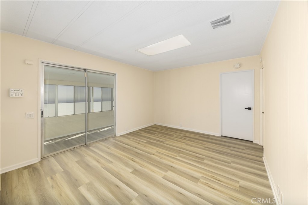 40975 Laredo Trail Cherry Valley, CA 92223 - Photo 20 of 34 an empty room with wooden floor and windows