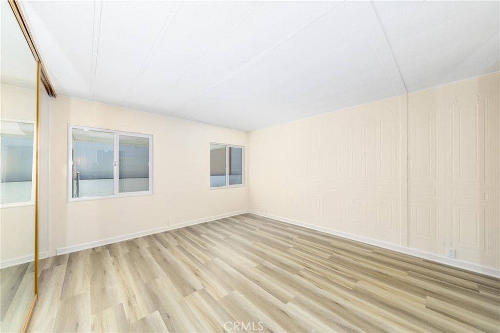 40975 Laredo Trail Cherry Valley, CA 92223 - Photo 27 of 34 a view of an empty room with wooden floor and a window