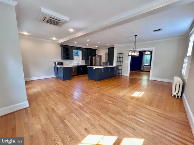 a kitchen with stainless steel appliances kitchen island granite countertop wooden cabinets and sink