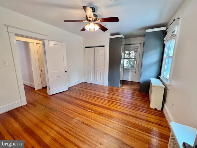 a view of hallway with wooden floor