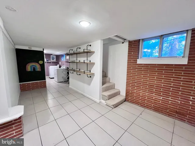 a utility room with cabinets washer and dryer