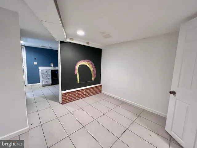 a backyard of a house with large trees and plants