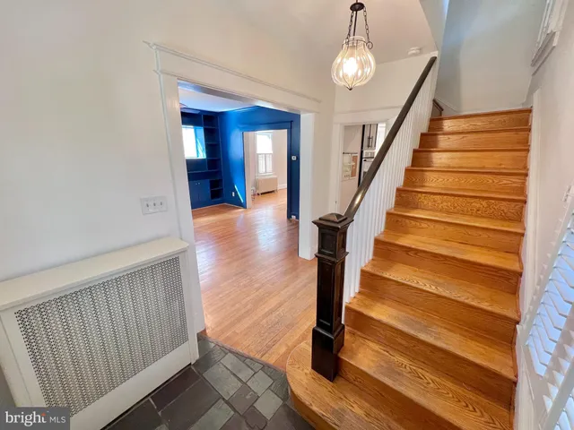 a view of an empty room fire place and a refrigerator