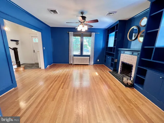 a view of a kitchen with wooden floor and windows