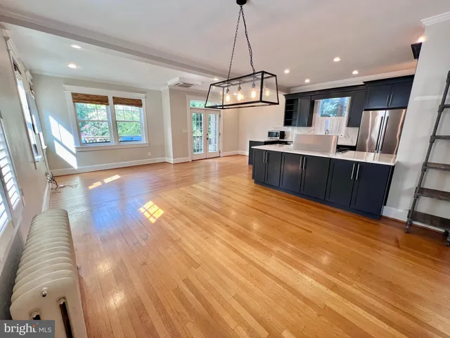 a living room with furniture and kitchen view