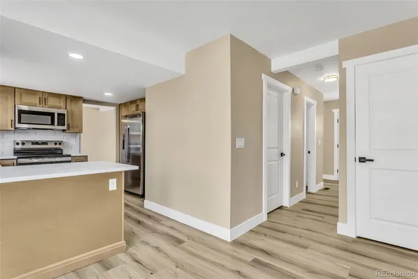 a kitchen with stainless steel appliances a refrigerator and a stove top oven