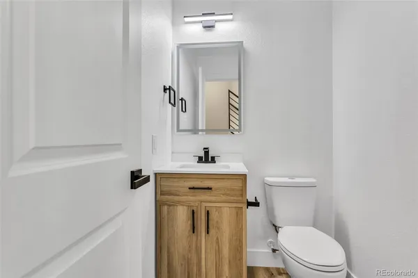 a bathroom with a sink a toilet and mirror