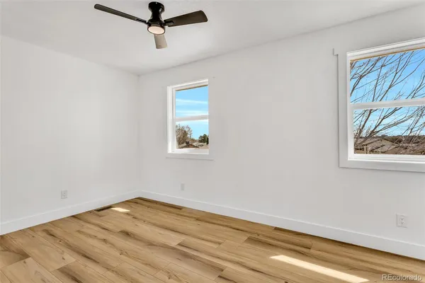 a view of a room with wooden floor and window