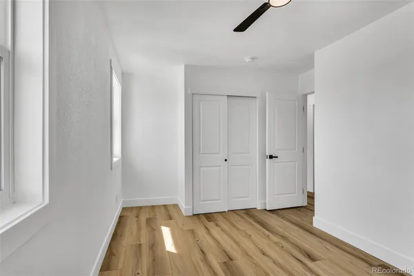 a view of an empty room and wooden floor
