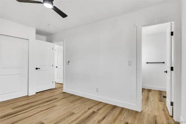 a view of empty room with wooden floor