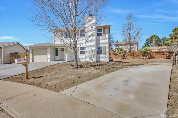 a view of a house with a tree in front