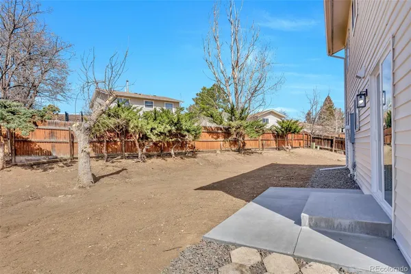 a view of a house with a wooden fence