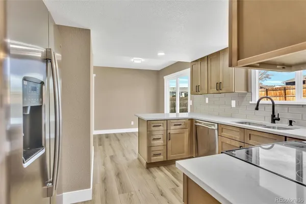 a kitchen with a sink appliances and cabinets