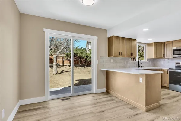 a view of kitchen with granite countertop window and sink