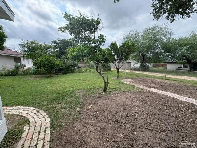 a view of backyard of house with green space
