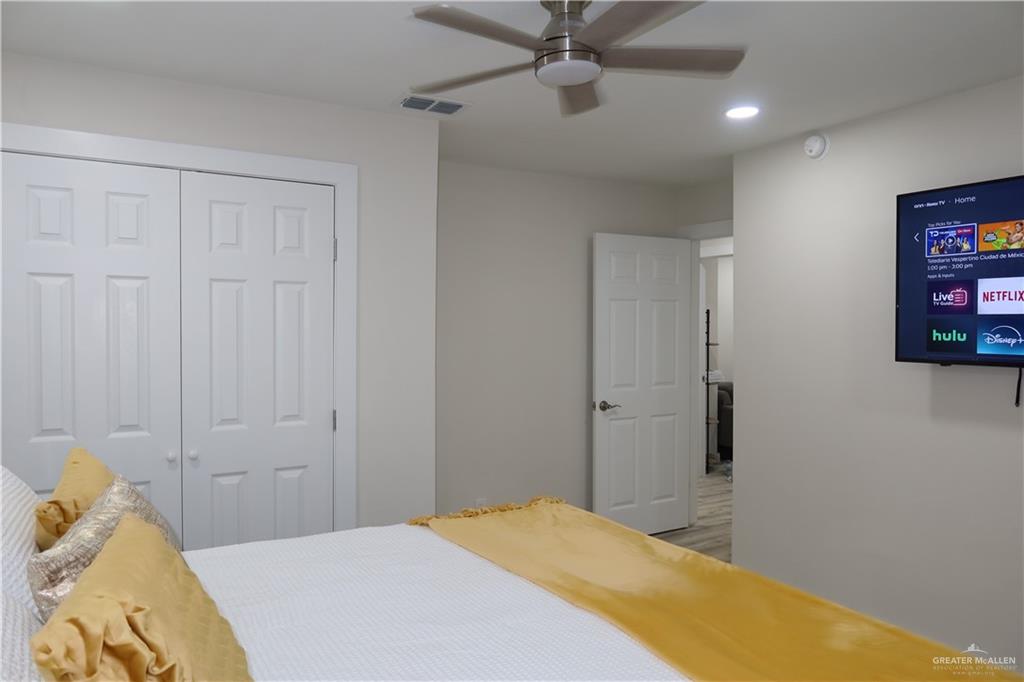 2617 Daytona Avenue McAllen, TX 78503 - Photo 7 of 17 a bedroom with a bed and a chandelier