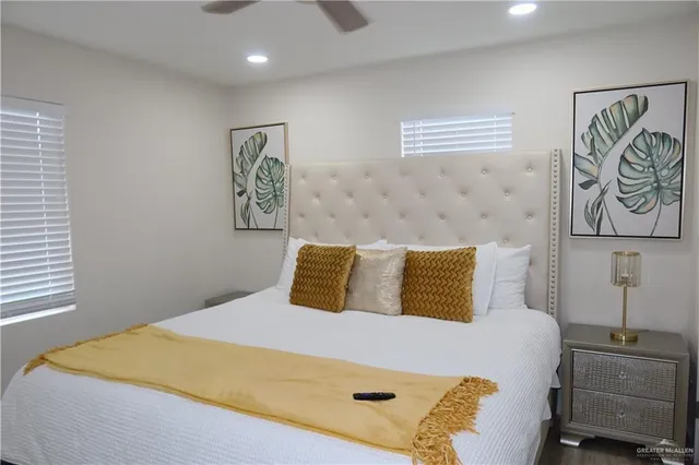 a bedroom with a bed and painting on the wall