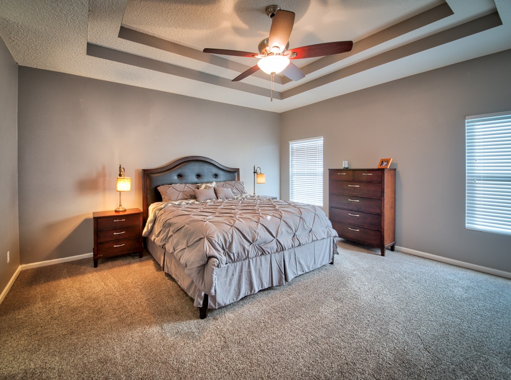 95199 Windflower Trail Fernandina Beach, FL 32034 - Photo 13 of 29 a bedroom with a bed and a ceiling fan