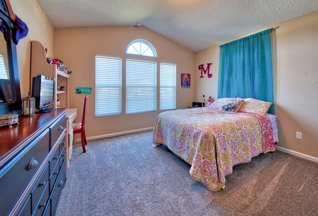 95199 Windflower Trail Fernandina Beach, FL 32034 - Photo 16 of 29 a bedroom with a bed and a flat tv screen on dresser