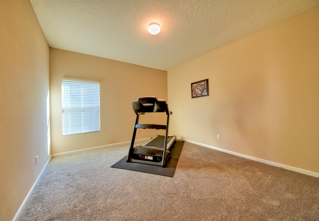 95199 Windflower Trail Fernandina Beach, FL 32034 - Photo 17 of 29 a room with gym equipment and windows