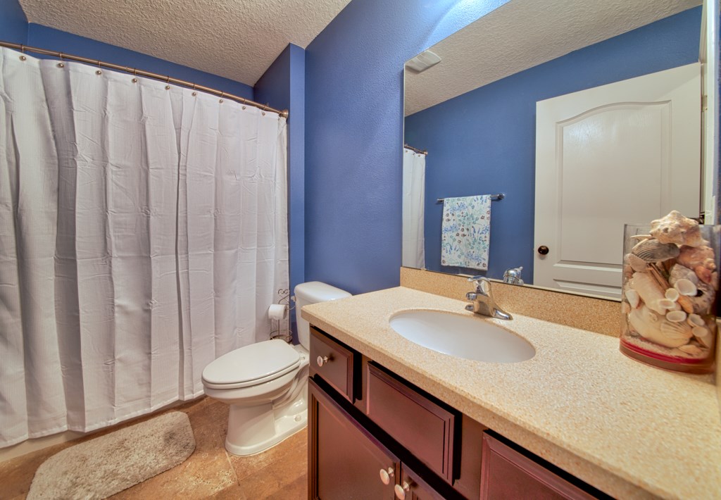 95199 Windflower Trail Fernandina Beach, FL 32034 - Photo 18 of 29 a bathroom with a sink a toilet and shower curtain