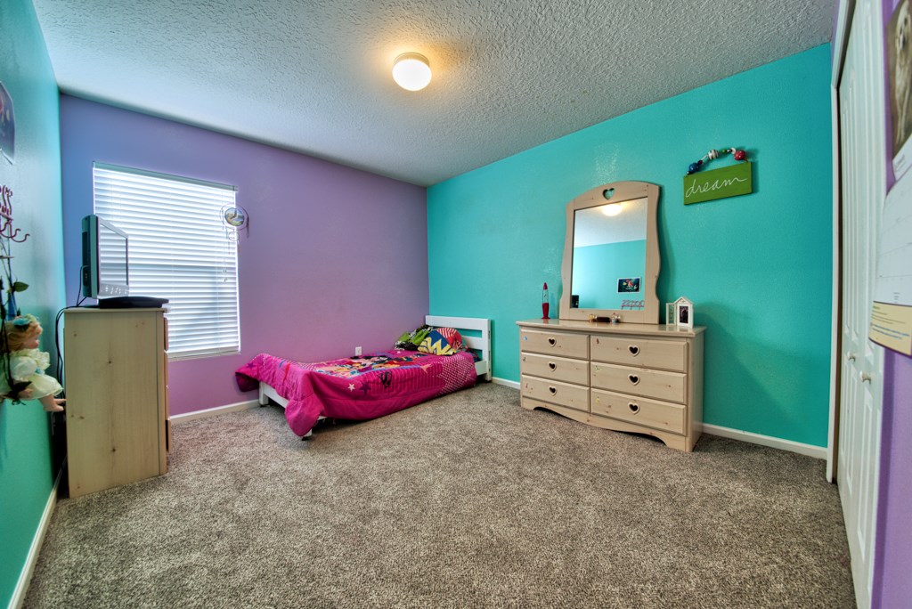 95199 Windflower Trail Fernandina Beach, FL 32034 - Photo 19 of 29 a bedroom with a bed and a mirror