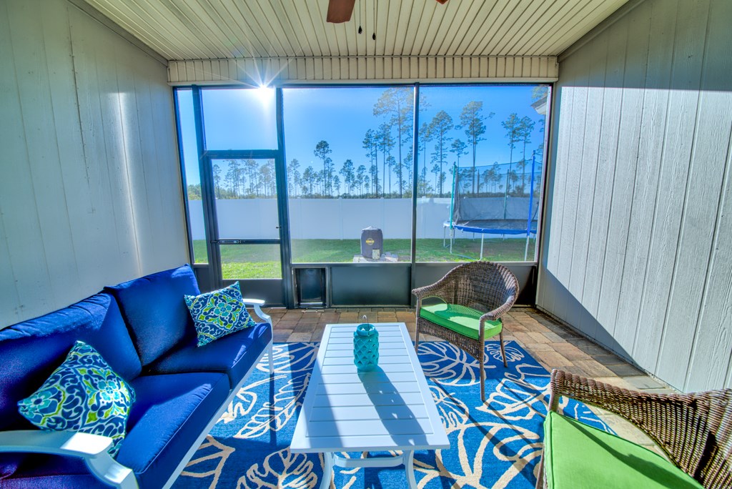 95199 Windflower Trail Fernandina Beach, FL 32034 - Photo 25 of 29 a living room with furniture and a floor to ceiling window