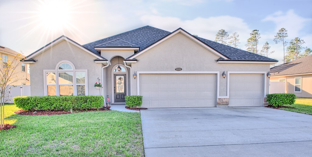95199 Windflower Trail Fernandina Beach, FL 32034 - Photo 29 of 29 a front view of a house with garden