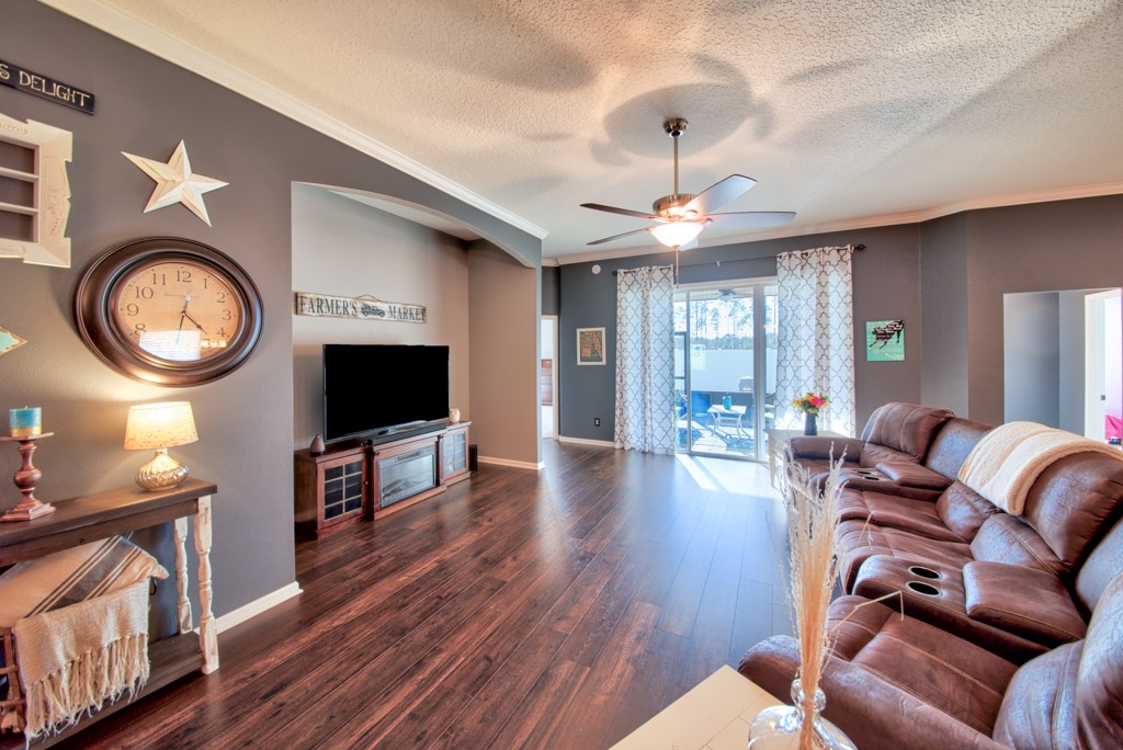 95199 Windflower Trail Fernandina Beach, FL 32034 - Photo 5 of 29 a living room with furniture a flat screen tv and a fireplace