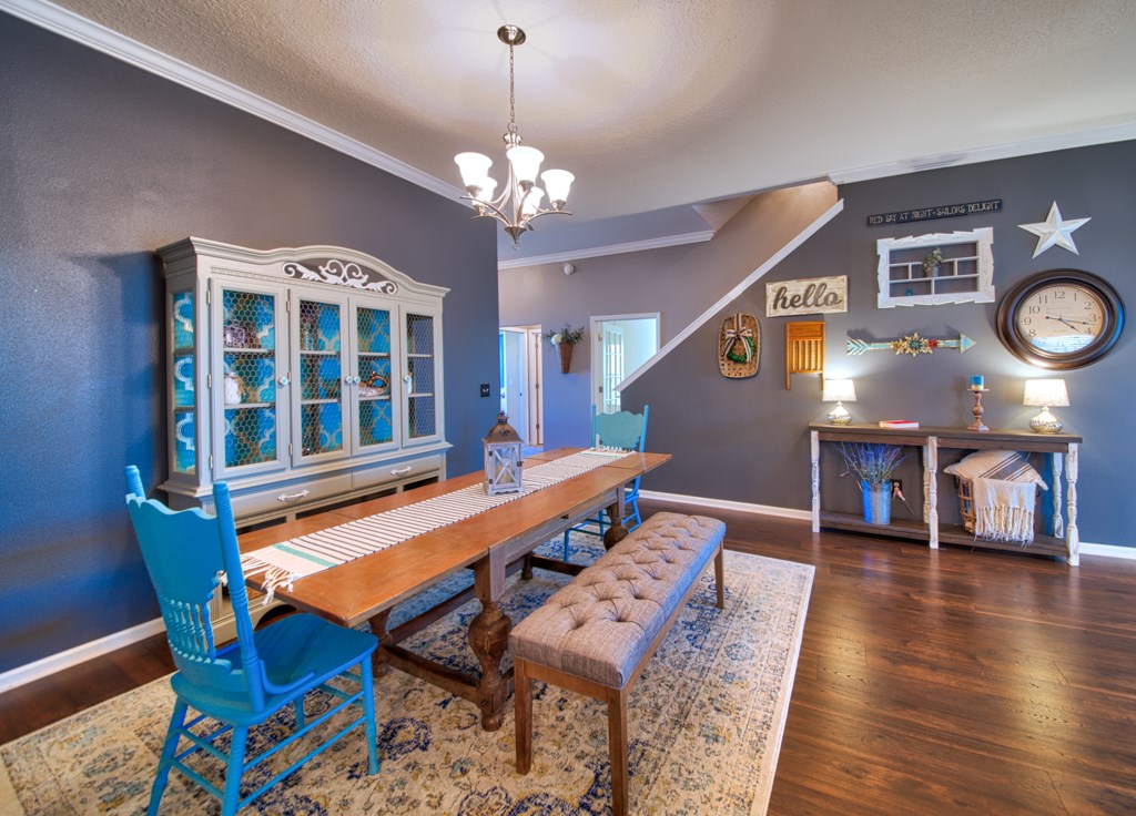 95199 Windflower Trail Fernandina Beach, FL 32034 - Photo 8 of 29 a dining room with wooden floor and a chandelier