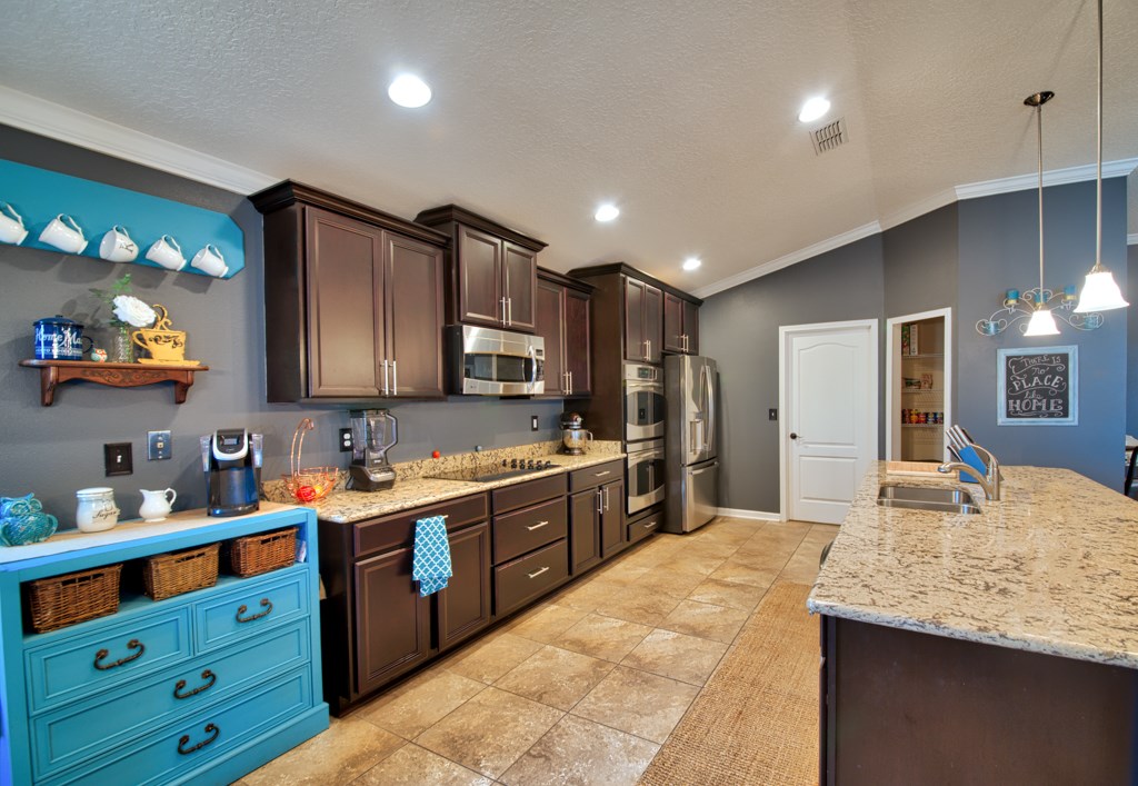 95199 Windflower Trail Fernandina Beach, FL 32034 - Photo 9 of 29 a large kitchen with kitchen island a sink stainless steel appliances and cabinets