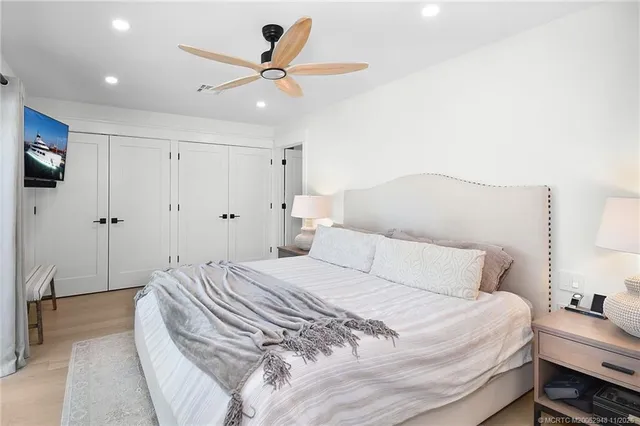 a bedroom with a bed and a large window