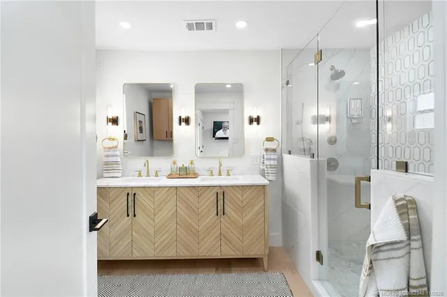a bathroom with a granite countertop sink a toilet and shower