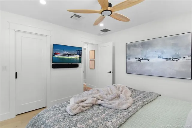 a bedroom with two beds and a chandelier