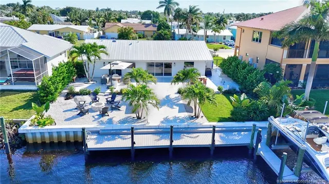a view of a patio with couches table and chairs and potted plants