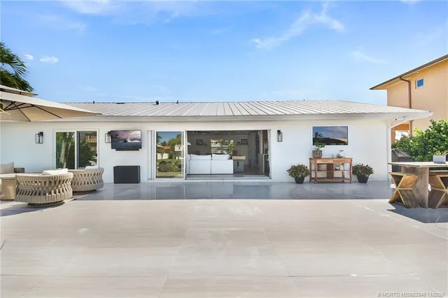 a view of a patio with couches and a potted plant