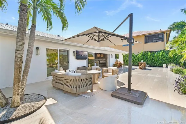 a view of a patio with table and chairs and potted plants