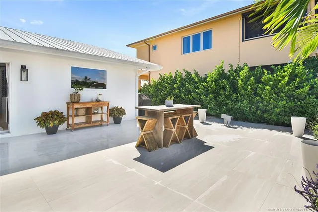 a view of a patio with furniture and a garden