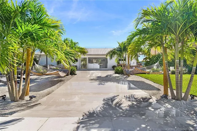 a view of a patio with couches and potted plants