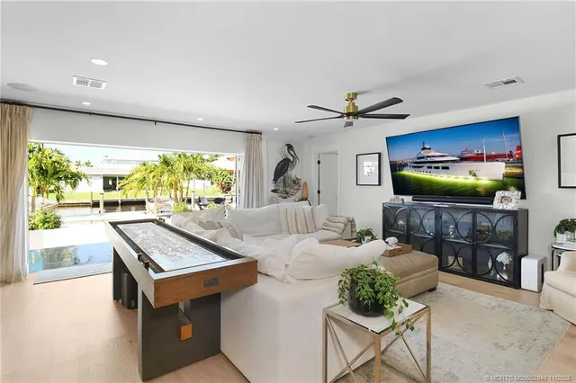 a kitchen with stainless steel appliances granite countertop a stove refrigerator a oven with a dining table and chairs