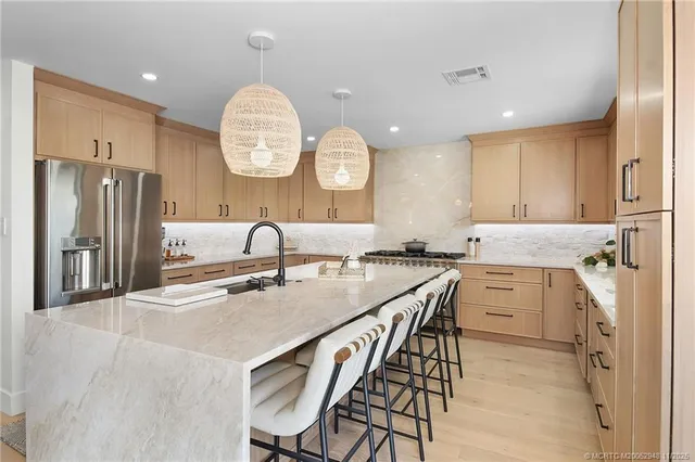 a kitchen with granite countertop cabinets stainless steel appliances and sink