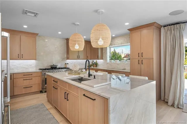 a kitchen with a sink dishwasher a stove and a refrigerator with wooden floor