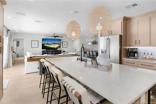 a kitchen with kitchen island granite countertop a sink stove and refrigerator