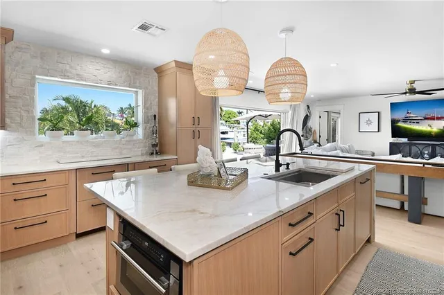 a kitchen with stainless steel appliances granite countertop a sink and a stove